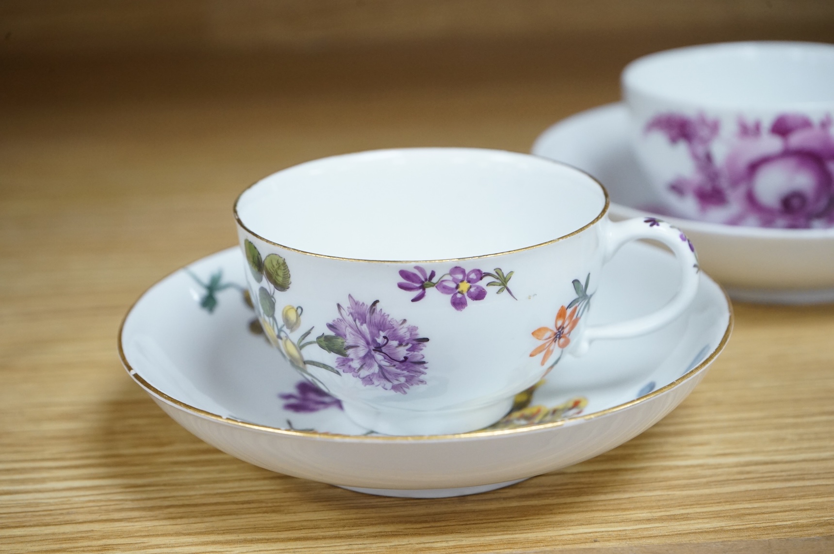 Two 18th century Meissen floral decorated teacups and saucers, largest saucer 13.5cm diameter